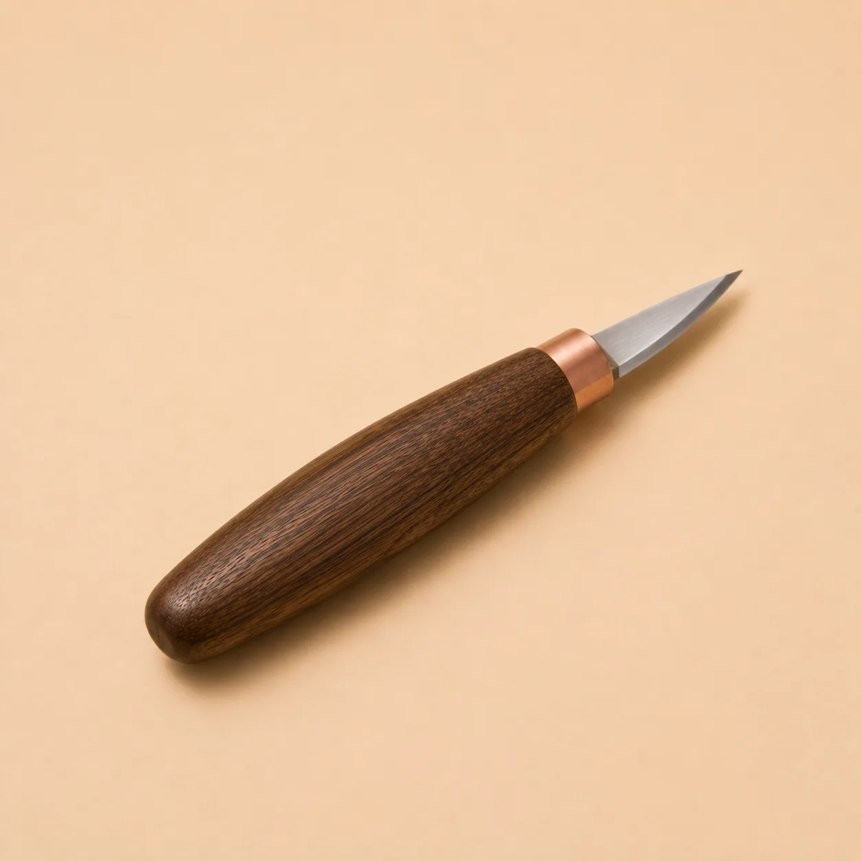 The trimming knife photographed alone, its small pointed blade set in a walnut handle